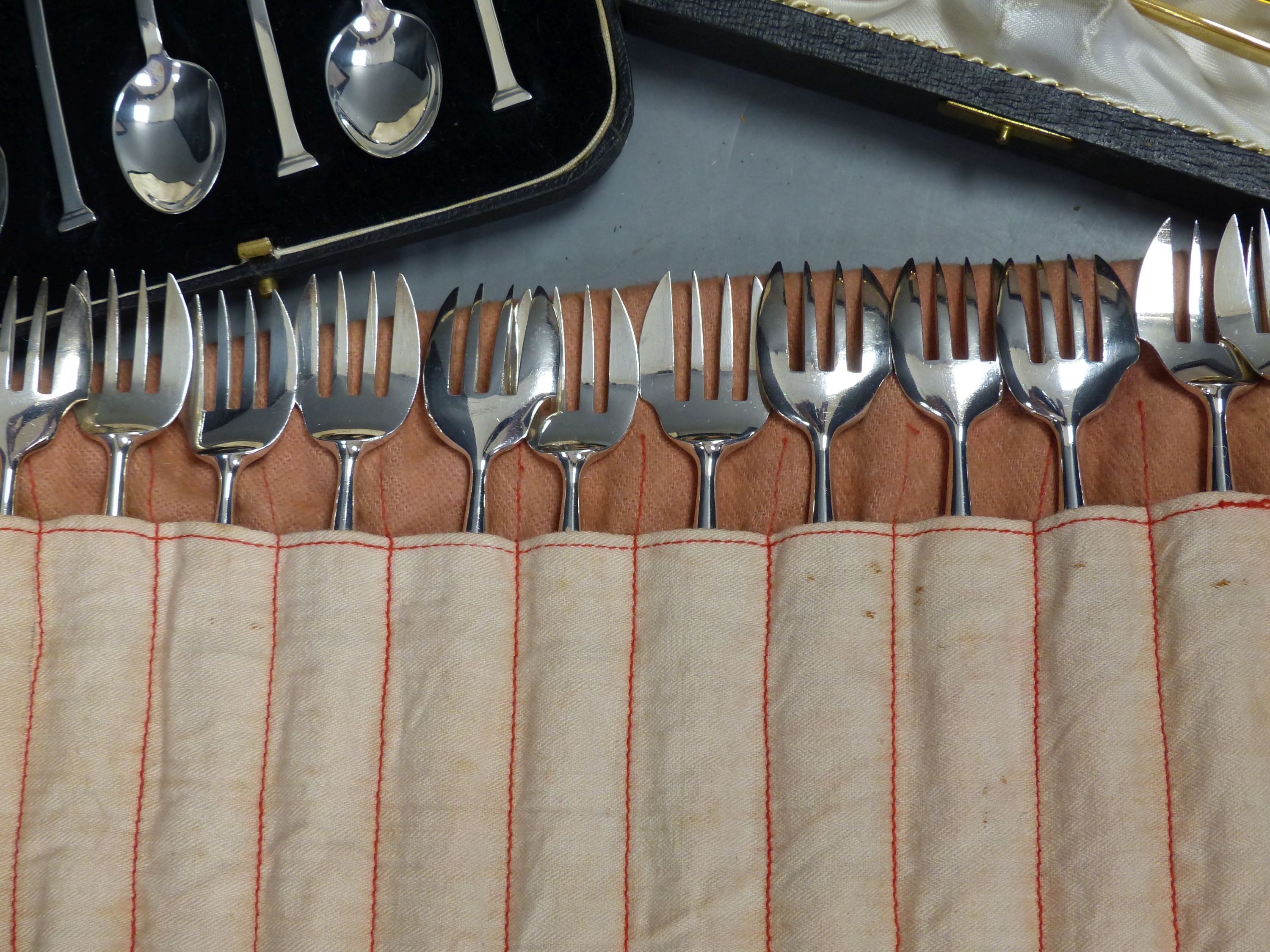 A set of twelve Christofle forks, a cased set of English coffee spoons and a set of Solingen gold-plated spoons.
